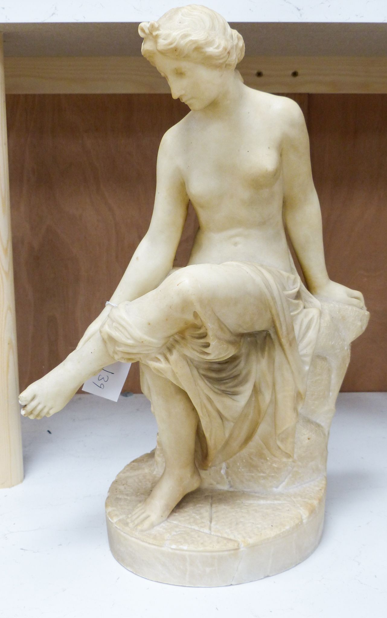 A 19th century Italian carved alabaster figure of a seated lady after the Antique, 45cm